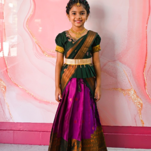 A traditional Indian Pattu Pavada lehenga in a vibrant Violet with forest Green