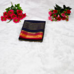 A deep midnight navy blue body contrasted with a bright crimson red border and pallu.