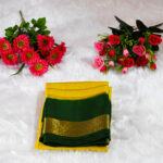 A deep mustard yellow (Body) contrasted with a vibrant deep emerald green (Border and Pallu).
