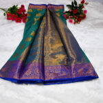 This specific garment combines a emerald green or rama green body with a contrasting royal blue pallu and border.