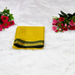 A bright mustard yellow body beautifully complemented by a deep emerald green border and pallu.