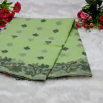 A soft, elegant pistachio green body contrasted by a vibrant dark green border and floral motifs.
